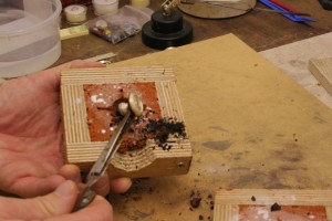taking out the cast silver with reverse tweezers